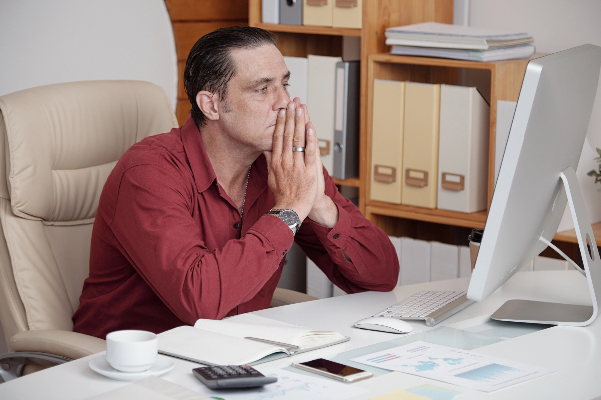 Frustrated business owner sitting alone at desk